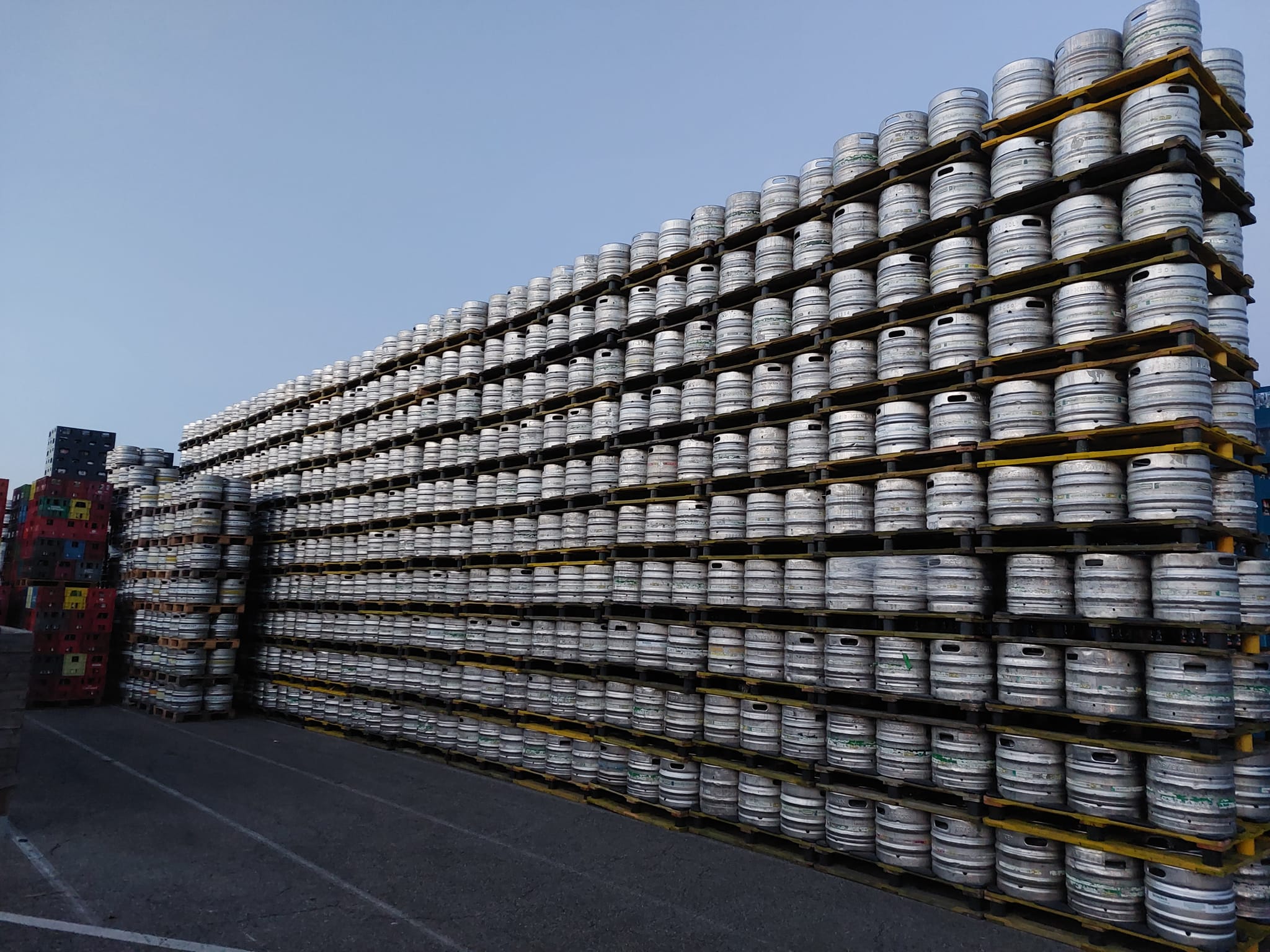 Used stainless steel kegs stacked on pallets